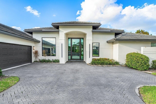 doorway to property with a garage