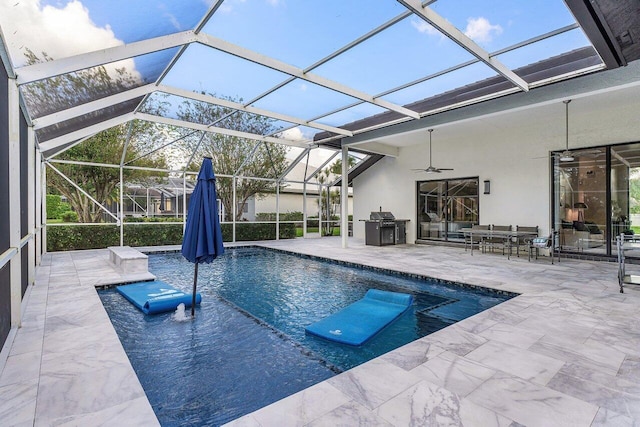 view of swimming pool featuring ceiling fan, a patio, and glass enclosure