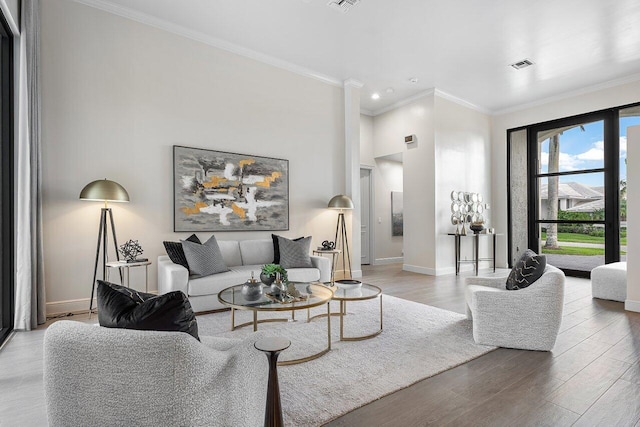 living room with hardwood / wood-style floors and crown molding