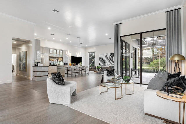 living room featuring wood-type flooring and ornamental molding