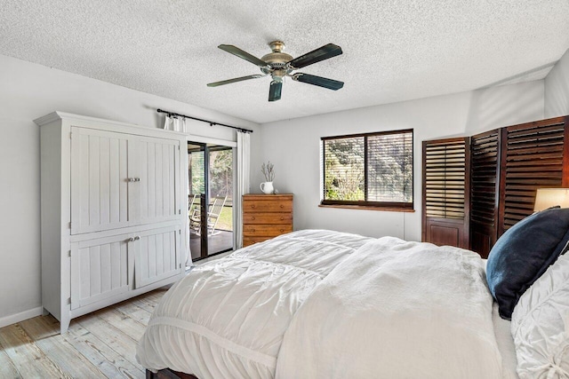 bedroom with access to exterior, a textured ceiling, light wood-type flooring, and ceiling fan