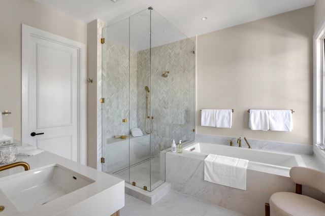bathroom featuring a garden tub, a stall shower, and vanity