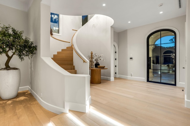 entrance foyer featuring visible vents, wood finished floors, recessed lighting, baseboards, and stairs
