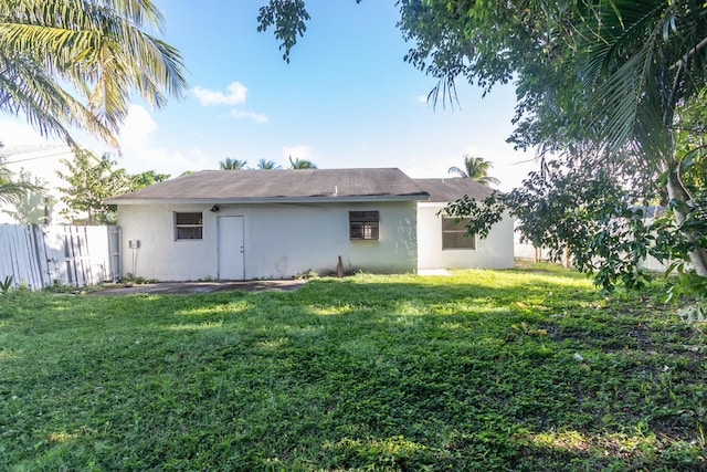 back of property featuring a lawn