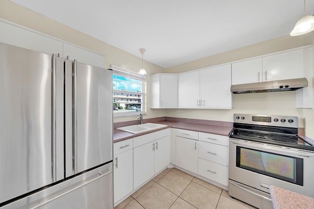 kitchen featuring white cabinets, hanging light fixtures, sink, and appliances with stainless steel finishes