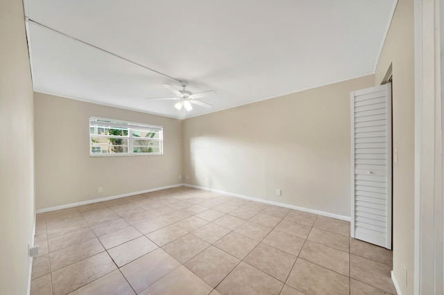 empty room featuring ceiling fan and light tile patterned flooring