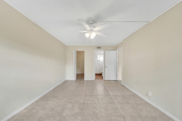 unfurnished bedroom featuring ceiling fan, light tile patterned floors, and a closet