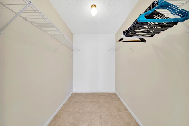 walk in closet with tile patterned floors