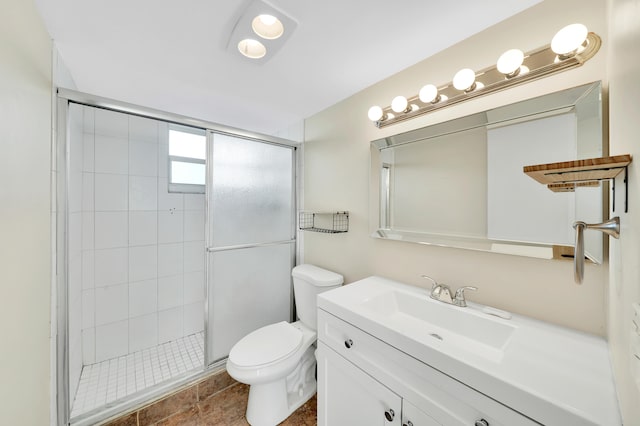 bathroom with tile patterned flooring, vanity, toilet, and a shower with door