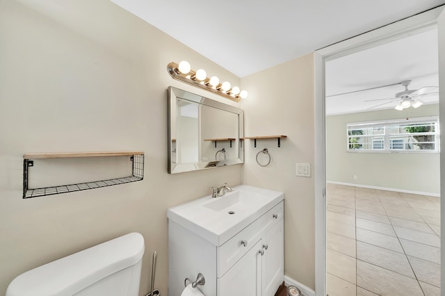 bathroom with tile patterned floors, vanity, ceiling fan, and toilet