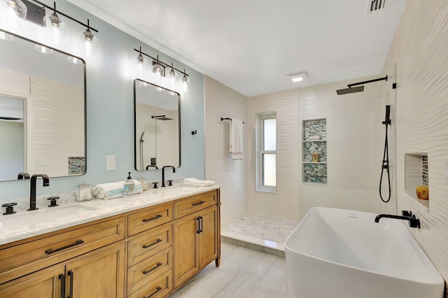 full bath with double vanity, a sink, and a walk in shower