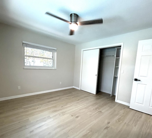 unfurnished bedroom with a closet, a ceiling fan, light wood-type flooring, and baseboards