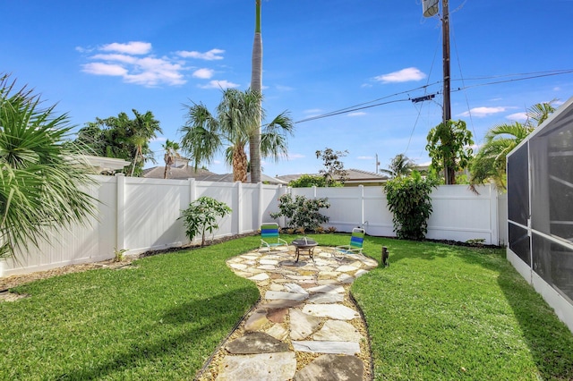 view of yard with a lanai, a fenced backyard, and a patio area