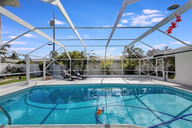 view of swimming pool with a fenced in pool, a patio, a fenced backyard, and glass enclosure