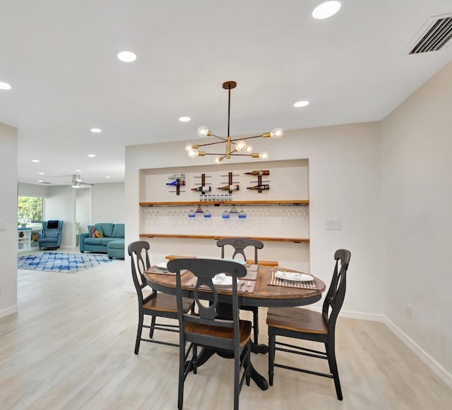 dining area featuring light wood-style floors, baseboards, visible vents, and recessed lighting