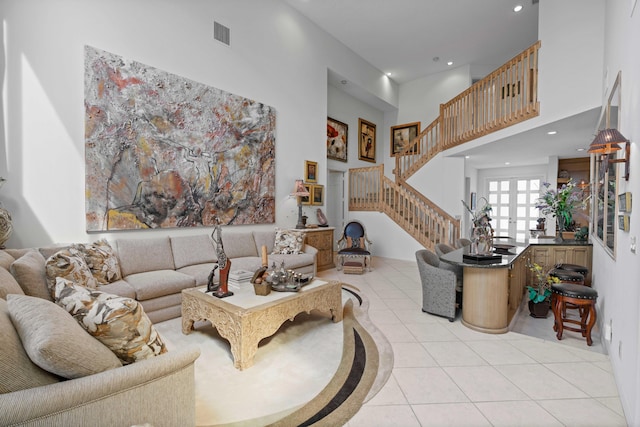 tiled living room featuring a high ceiling