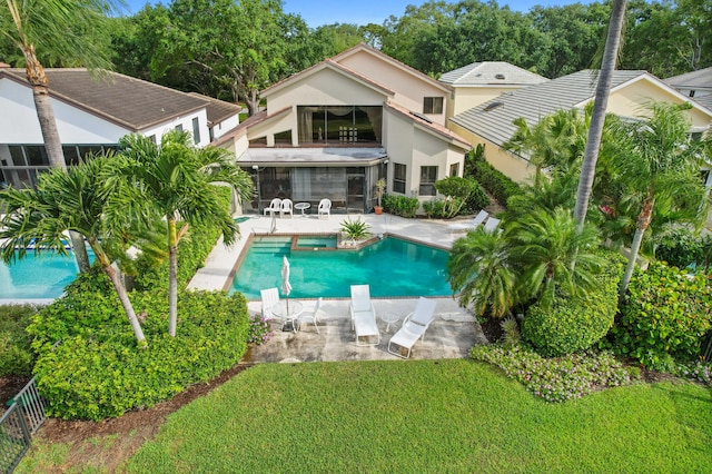 view of swimming pool with a patio area and a yard