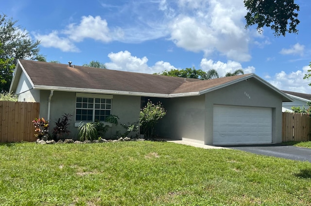 single story home featuring a front yard and a garage