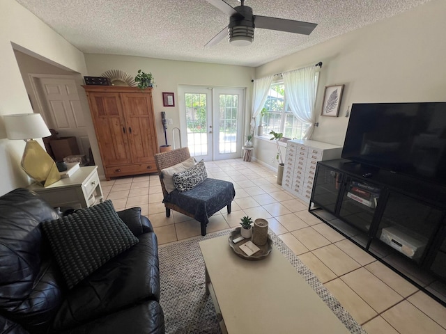 tiled living room featuring ceiling fan, a textured ceiling, and french doors