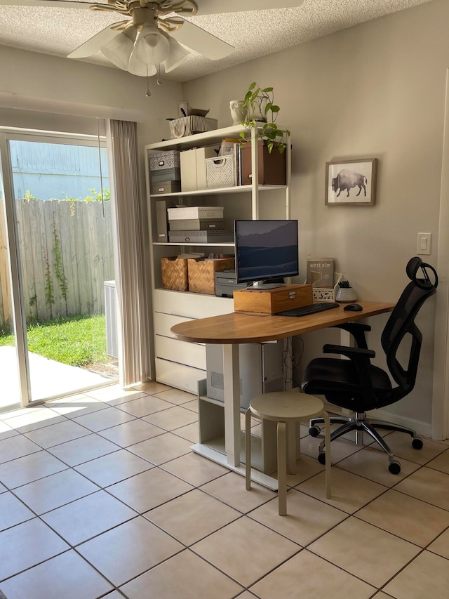 tiled office with ceiling fan, a textured ceiling, and a wealth of natural light