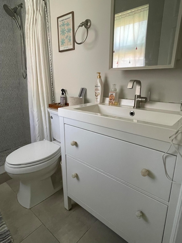 bathroom featuring tile patterned flooring, vanity, toilet, and a shower with shower curtain