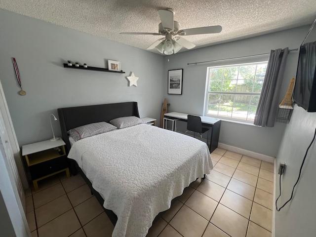 bedroom featuring light tile patterned floors, a textured ceiling, and ceiling fan