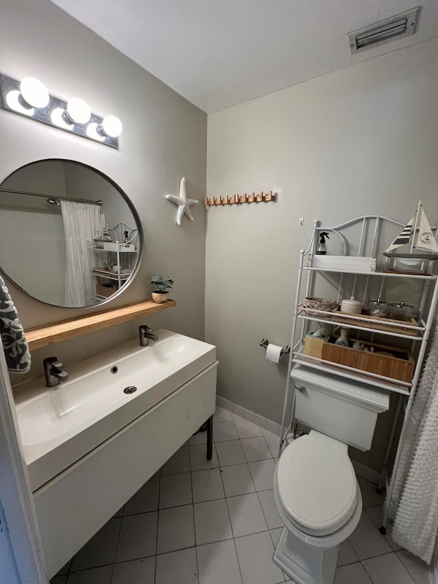 bathroom featuring tile patterned flooring and toilet