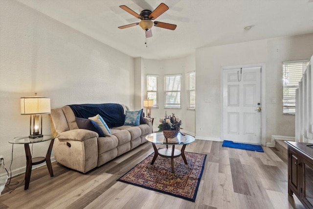 living room with light hardwood / wood-style floors and ceiling fan