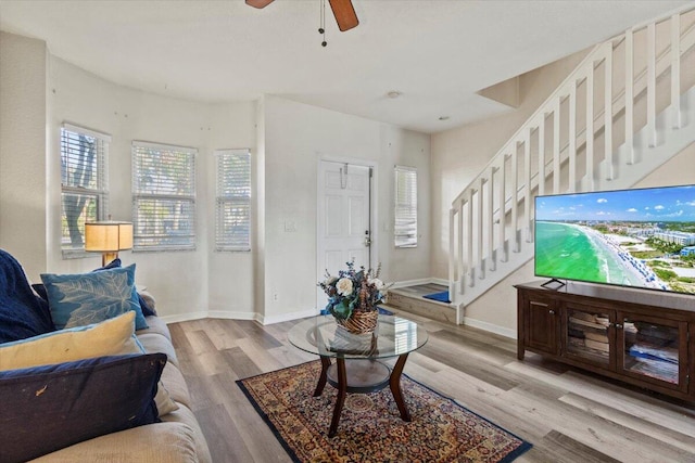 living room featuring ceiling fan and light wood-type flooring