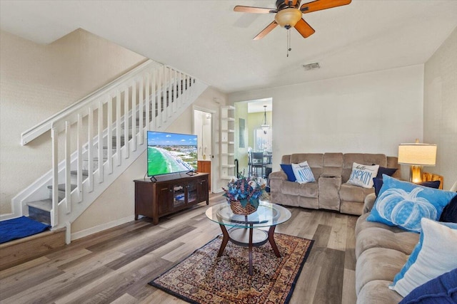 living room featuring ceiling fan and wood-type flooring