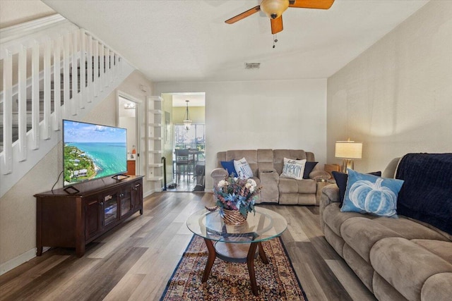 living room with ceiling fan and hardwood / wood-style flooring