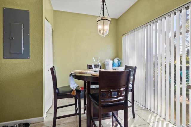 dining area featuring electric panel, light tile patterned floors, and an inviting chandelier