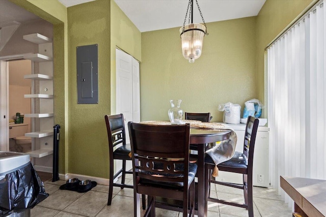 dining area featuring a notable chandelier, light tile patterned flooring, and electric panel