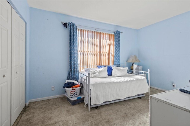 bedroom featuring light carpet and a closet