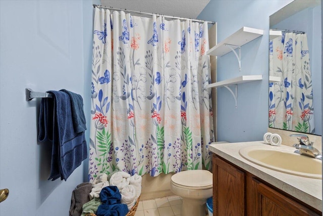 bathroom featuring tile patterned flooring, vanity, and toilet