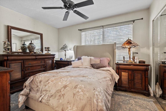 bedroom featuring ceiling fan and a textured ceiling