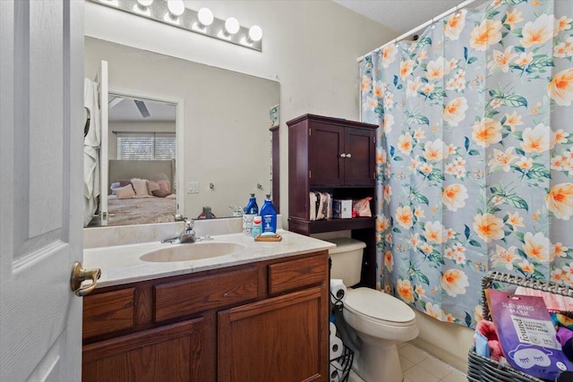 bathroom featuring tile patterned floors, vanity, and toilet