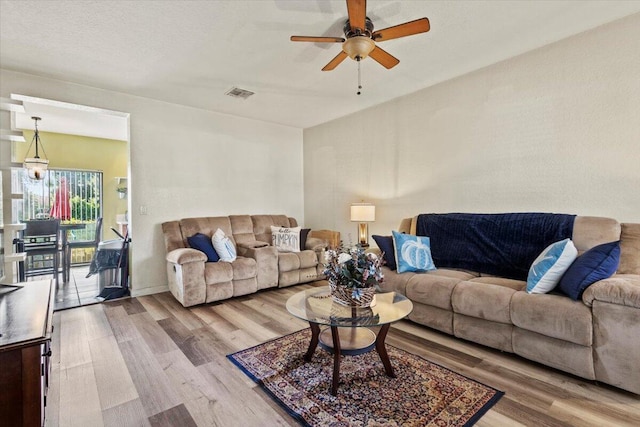 living room with hardwood / wood-style floors and ceiling fan