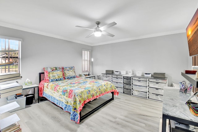 bedroom featuring ceiling fan, ornamental molding, and light hardwood / wood-style flooring