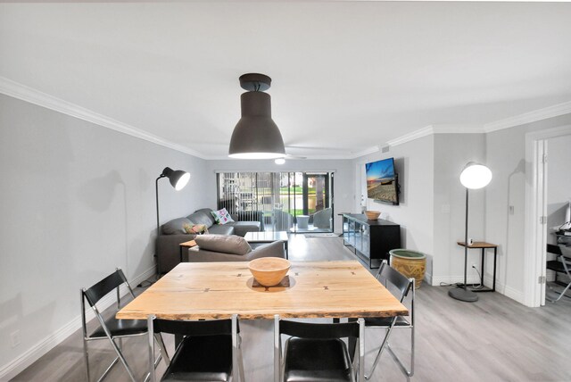 living room with hardwood / wood-style flooring, ceiling fan, and crown molding