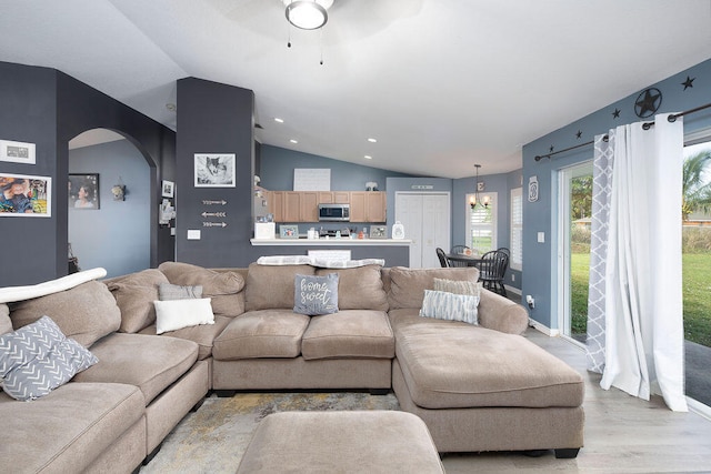 living room featuring vaulted ceiling and light hardwood / wood-style floors