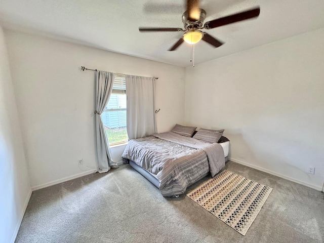 bedroom featuring ceiling fan and carpet