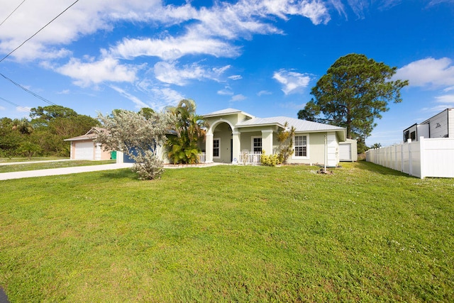 view of front facade featuring a garage, covered porch, and a front yard