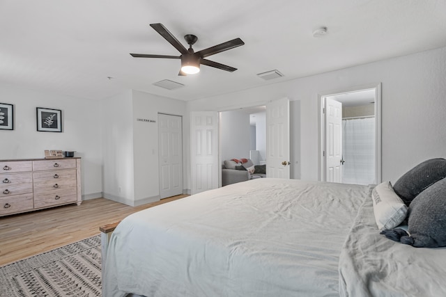 bedroom with ceiling fan, light hardwood / wood-style flooring, and ensuite bathroom