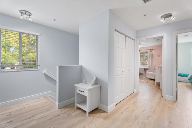 hall featuring plenty of natural light and light wood-type flooring