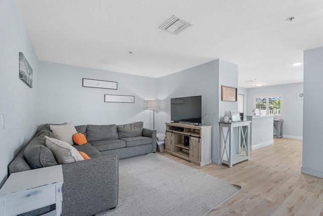 living room with light hardwood / wood-style flooring