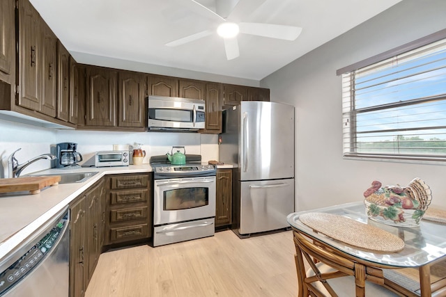 2300 NE 1st Ln Unit 307, Boynton Beach, FL 33435 - kitchen with stainless steel appliances, a sink, light countertops, and dark brown cabinetry