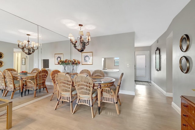 2300 NE 1st Ln Unit 307, Boynton Beach, FL 33435 - dining area with a chandelier, baseboards, and wood finished floors
