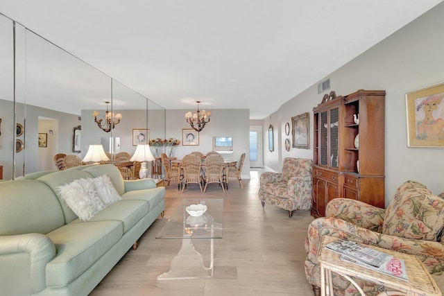 2300 NE 1st Ln Unit 307, Boynton Beach, FL 33435 - living area with a chandelier and light wood-type flooring