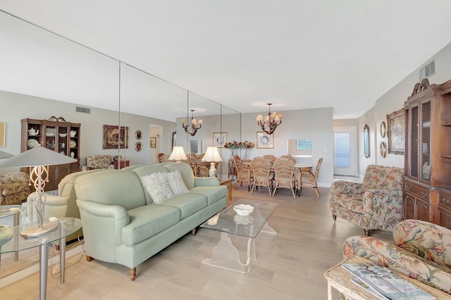 2300 NE 1st Ln Unit 307, Boynton Beach, FL 33435 - living area with a chandelier and light wood-style flooring